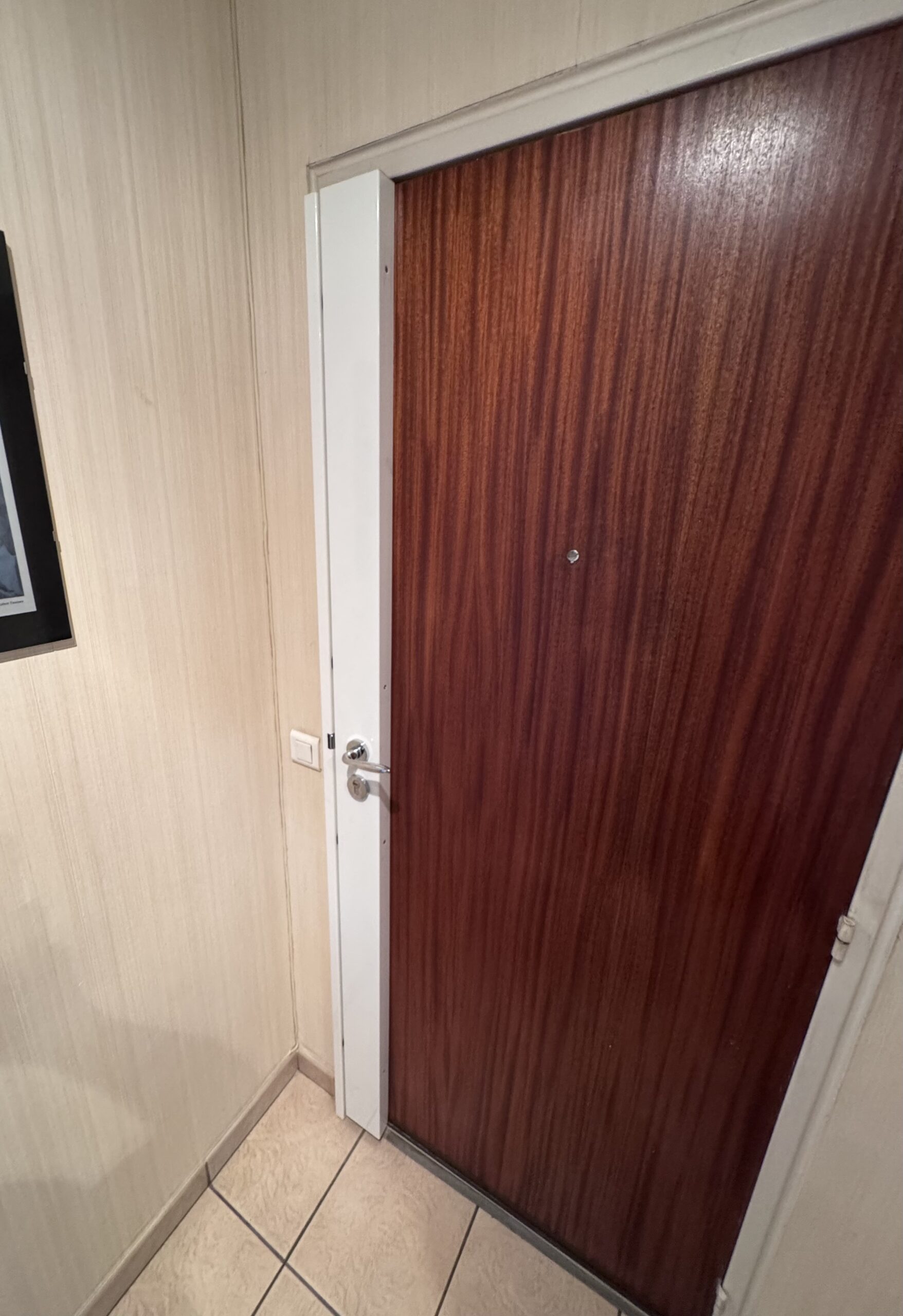 Full-length covered multipoint lock in white on a wooden door — MULTISECU